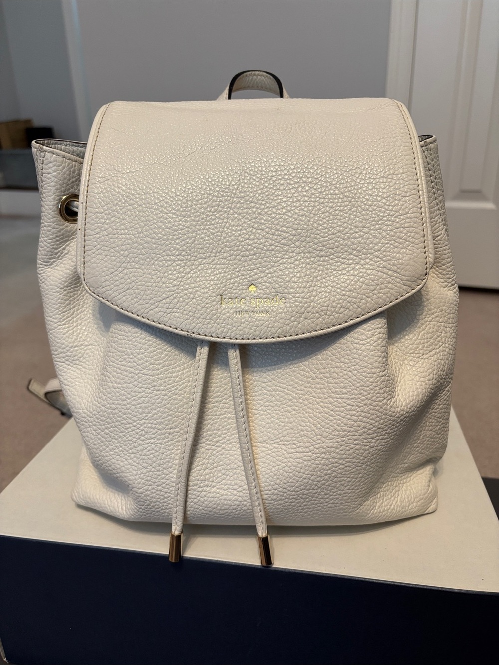kate spade Cream Pebbled Leather Drawstring Flap Backpack